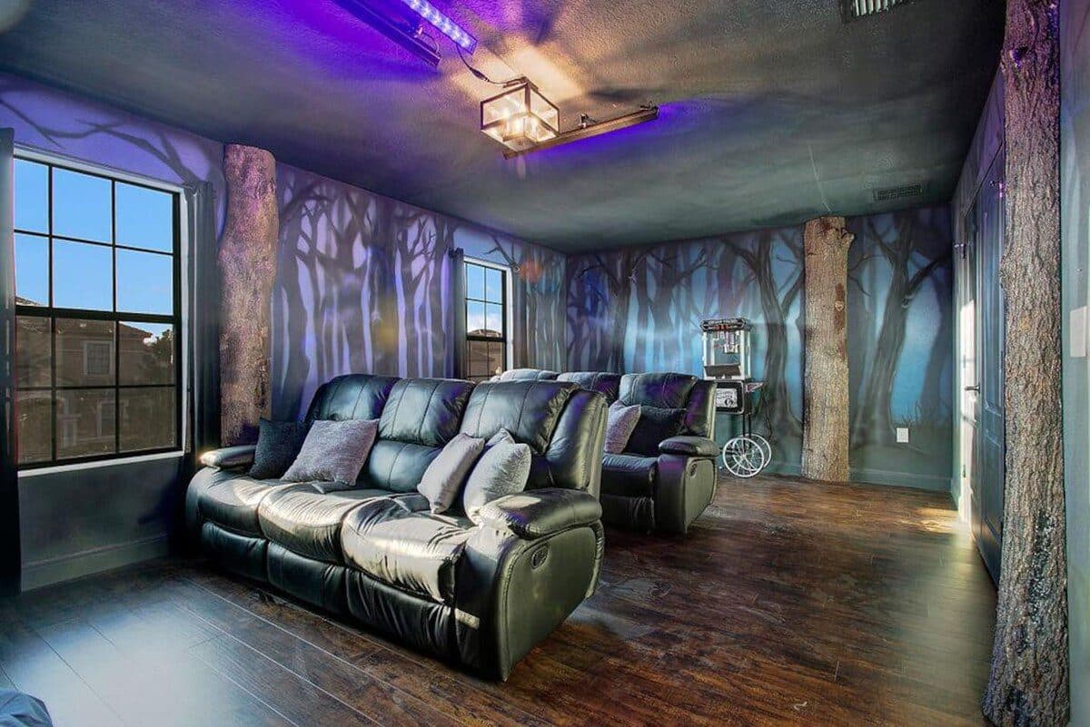 Whispering Woods Cinema — reclining seats, surround sound, blacklight murals
